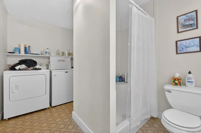a white toilet sitting next to a bathroom sink
