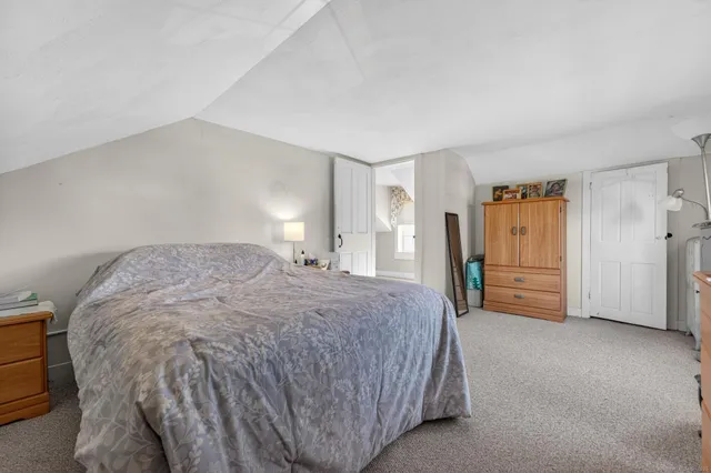 a spacious bedroom with a bed and a cabinets