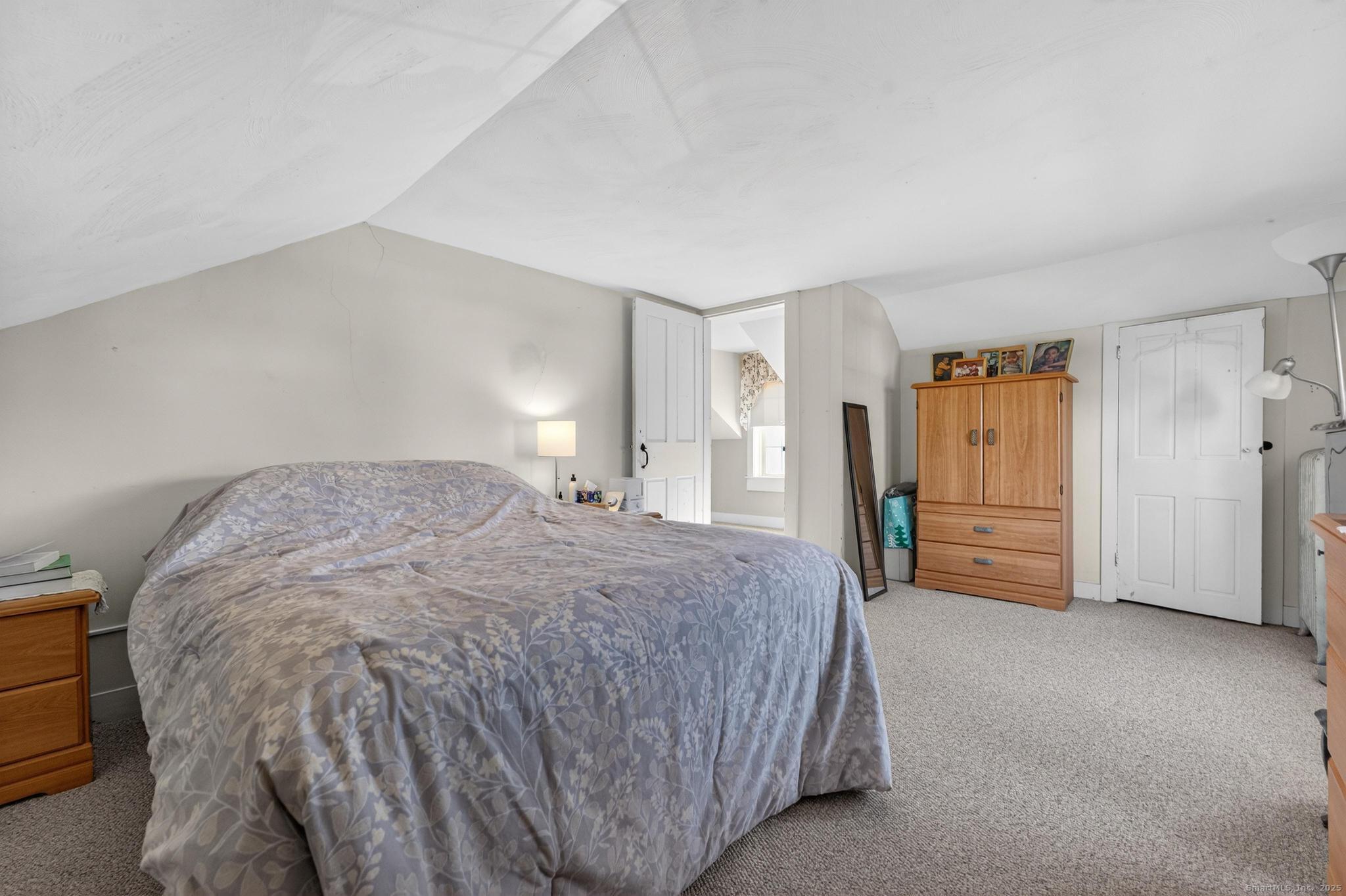 18 Broad Street Killingly, CT 06239 - Photo 14 of 21 a spacious bedroom with a bed and a cabinets