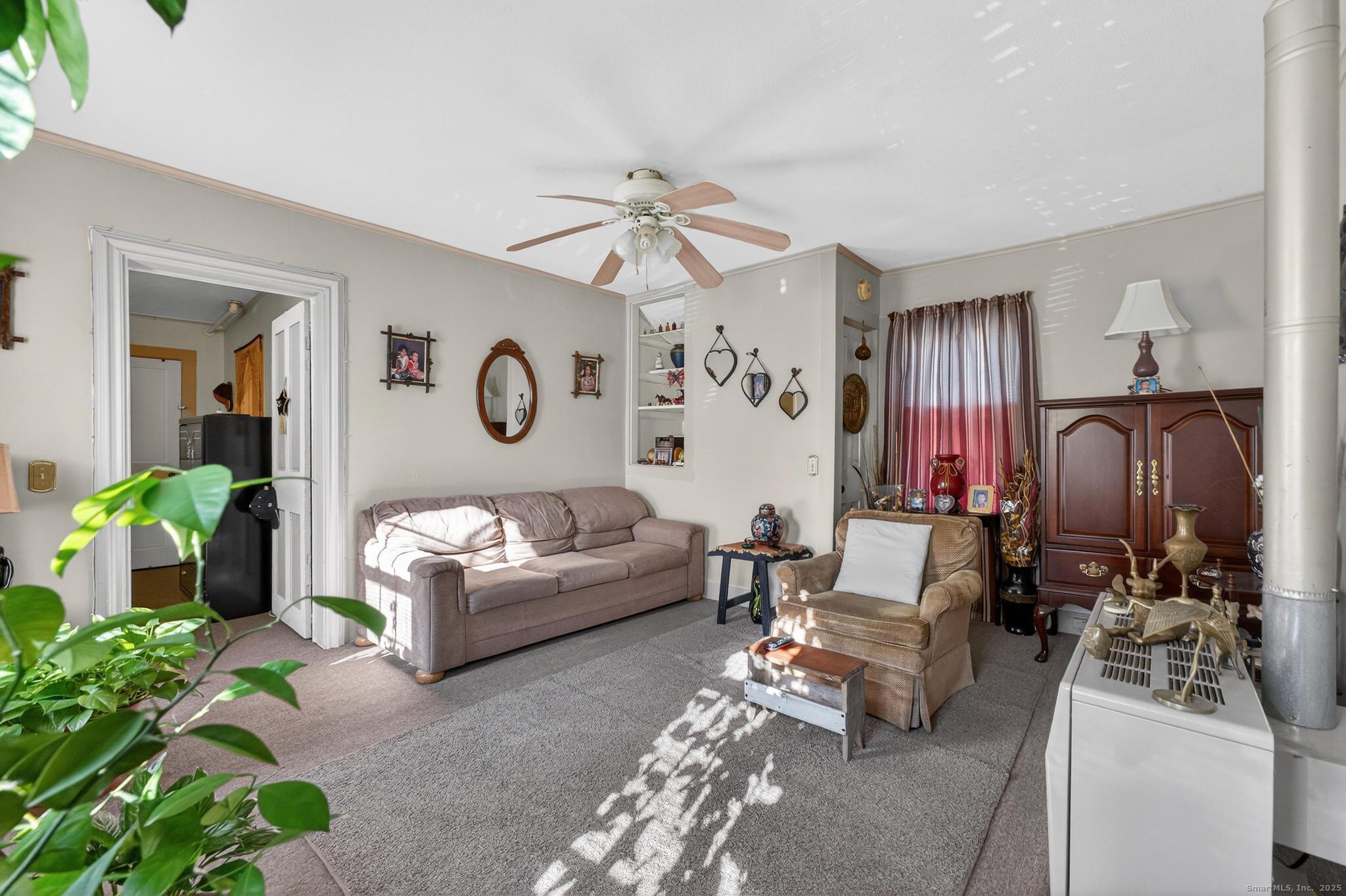 18 Broad Street Killingly, CT 06239 - Photo 19 of 21 a living room with furniture a chandelier and a mirror