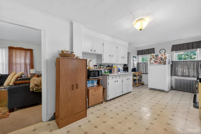 a kitchen with refrigerator and cabinets