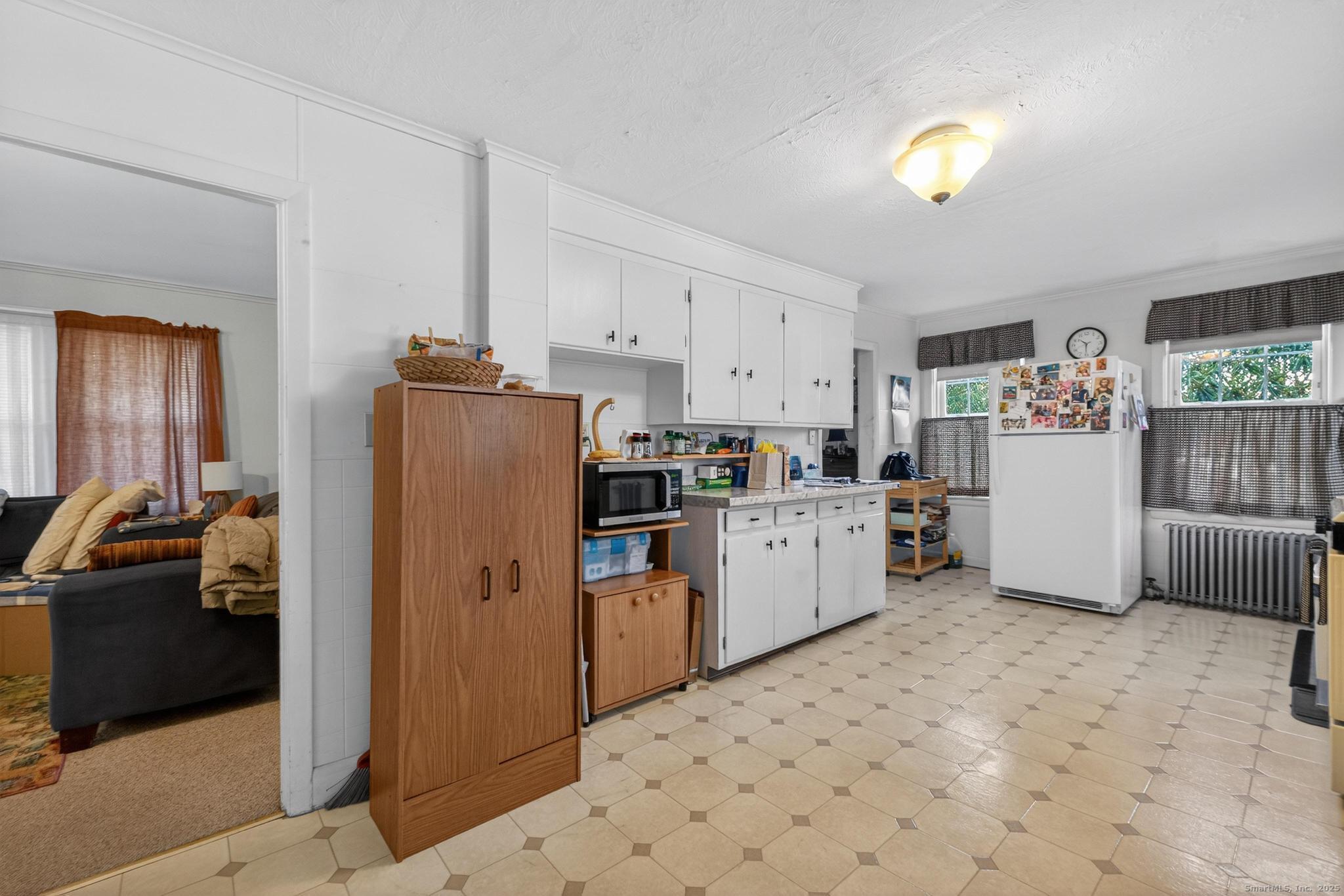 18 Broad Street Killingly, CT 06239 - Photo 8 of 21 a kitchen with refrigerator and cabinets