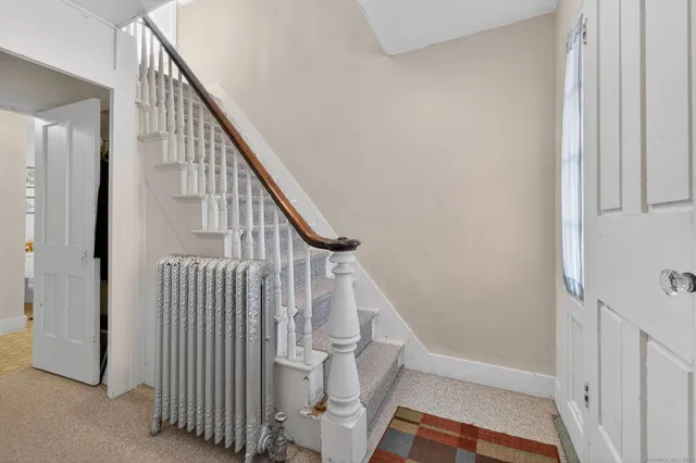 a view of entryway with wooden floor and stairs