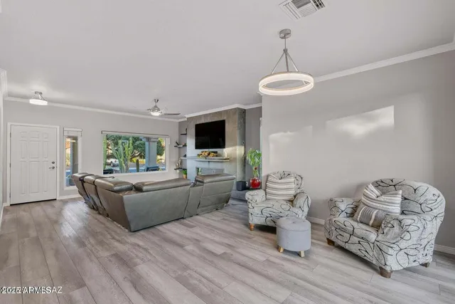 a bedroom with furniture and large windows