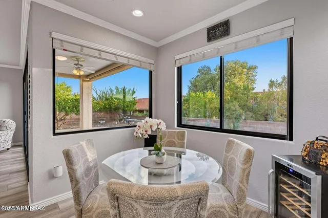 a kitchen with stainless steel appliances granite countertop a stove a sink a dining table and chairs