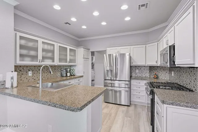 a dining room with furniture a flat screen tv and a large window