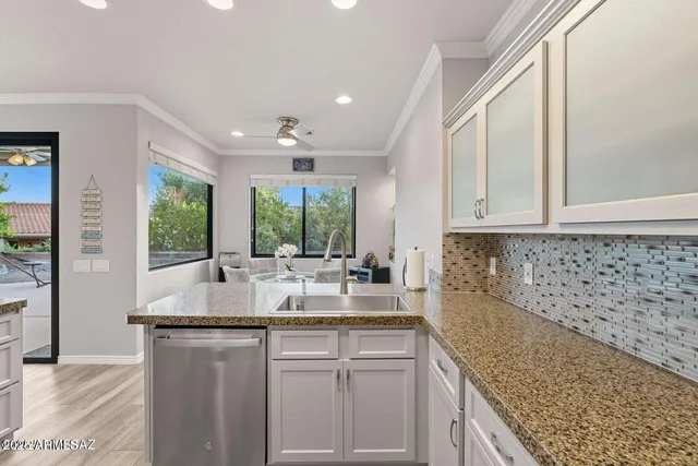 a kitchen with a sink stove and microwave