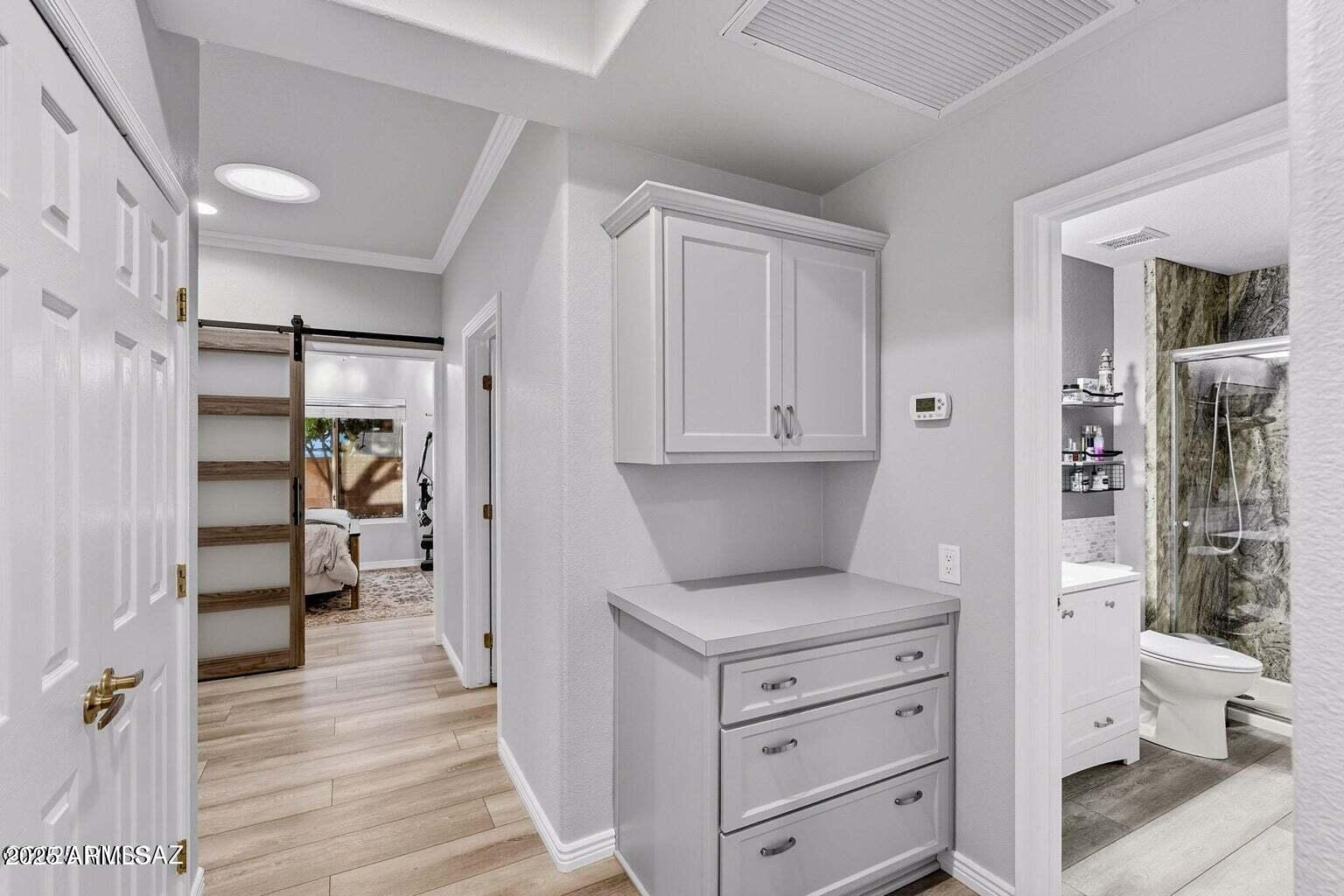 14705 North Palm Ridge Drive Oro Valley, AZ 85755 - Photo 22 of 49 a kitchen with a refrigerator and white cabinets