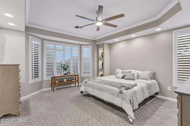 a kitchen with a refrigerator and white cabinets
