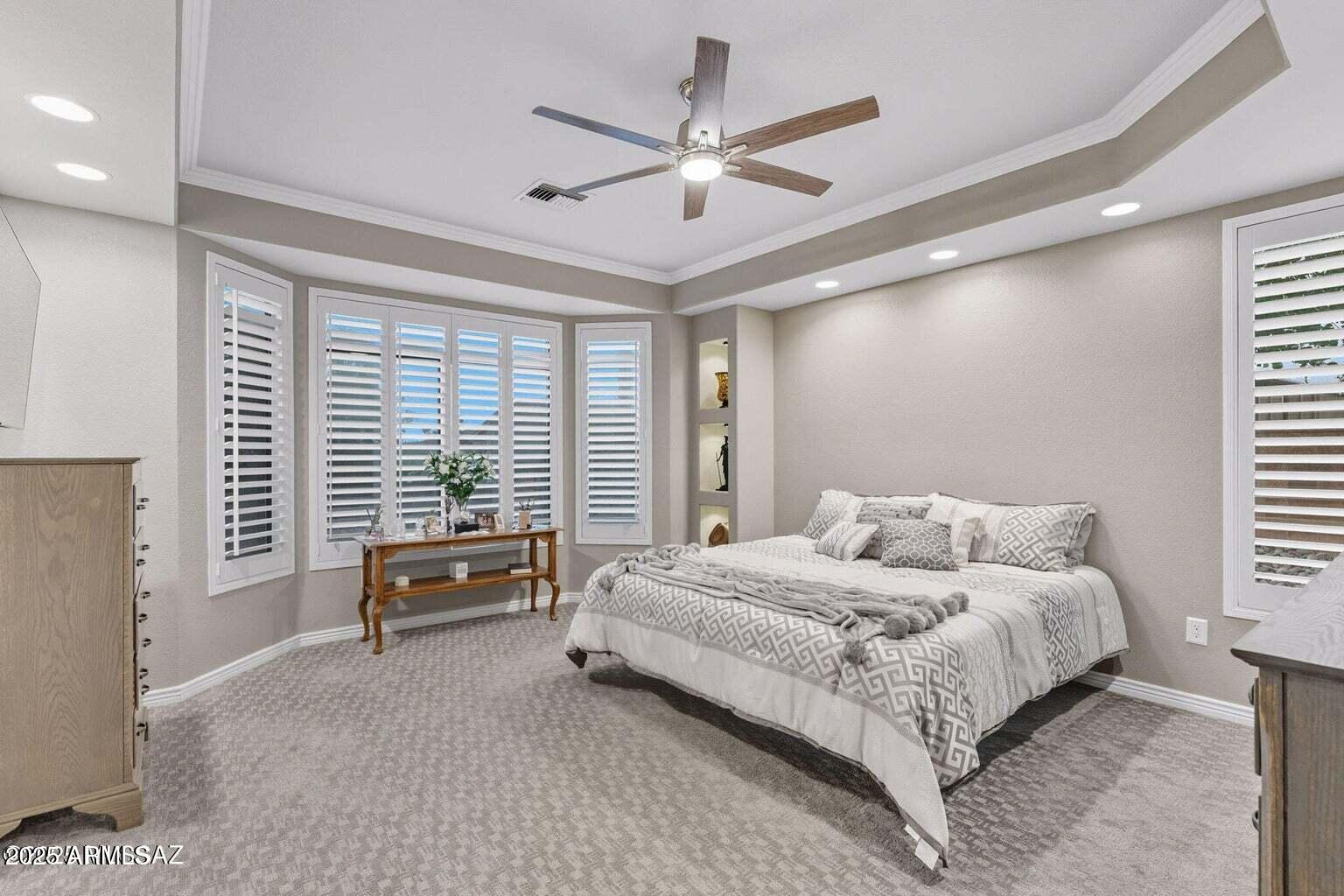 14705 North Palm Ridge Drive Oro Valley, AZ 85755 - Photo 23 of 49 a bedroom with a bed a couch and a ceiling fan