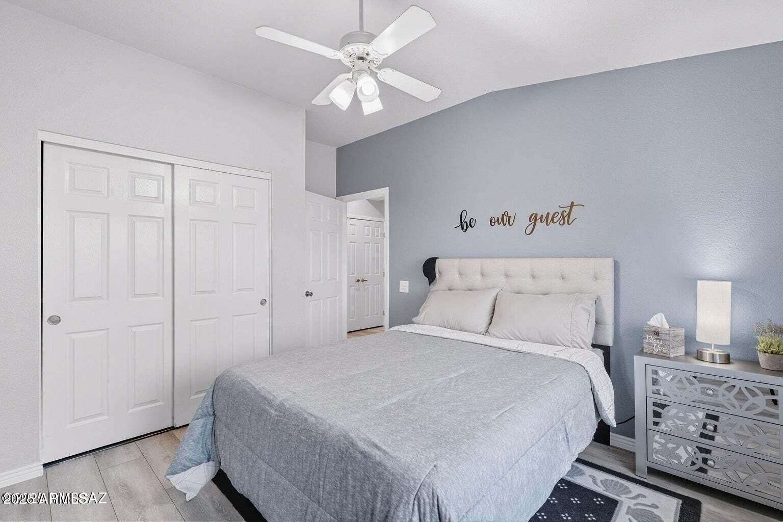 14705 North Palm Ridge Drive Oro Valley, AZ 85755 - Photo 29 of 49 a bedroom with a bed and a chandelier