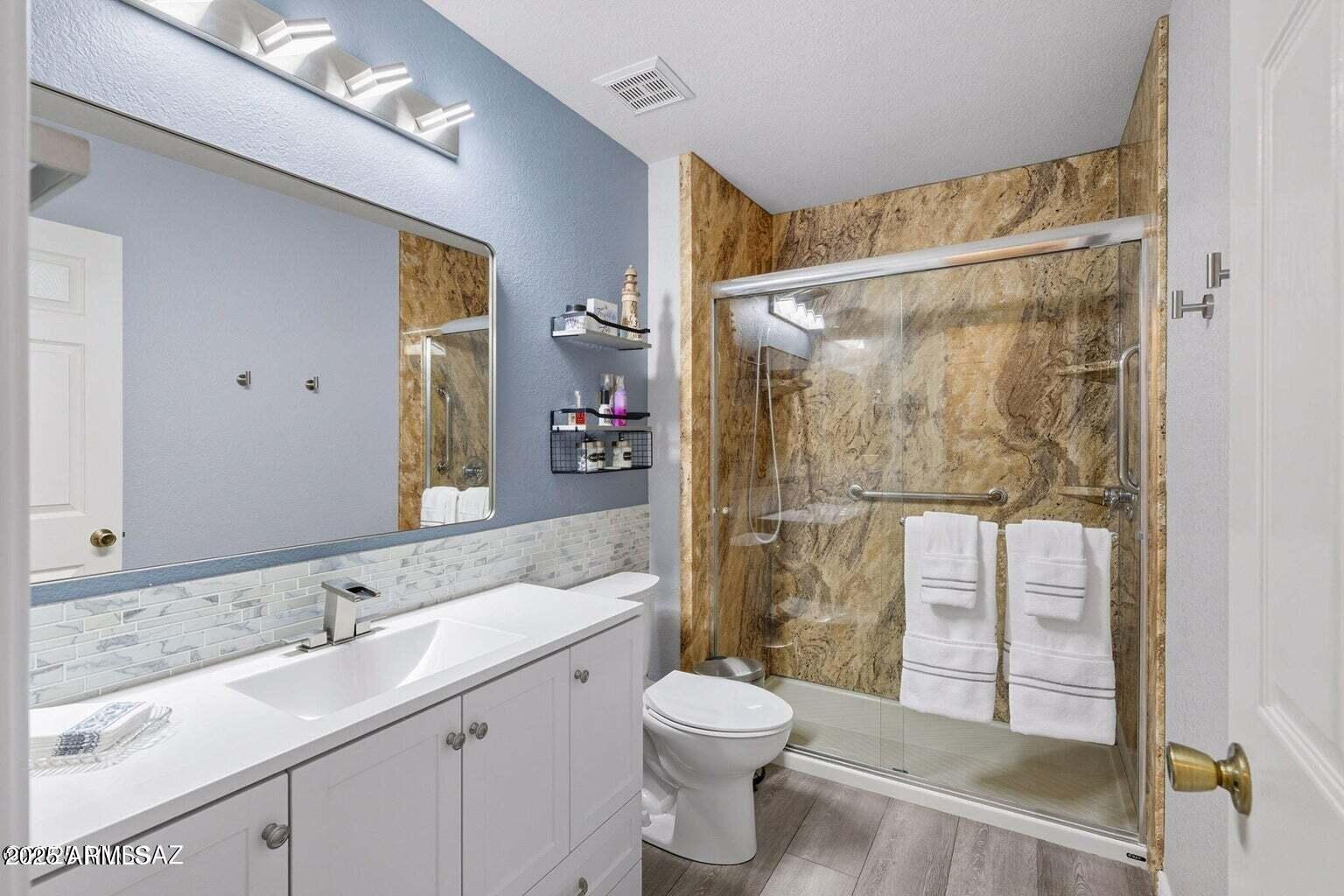 14705 North Palm Ridge Drive Oro Valley, AZ 85755 - Photo 30 of 49 a bathroom with a granite countertop sink toilet and shower