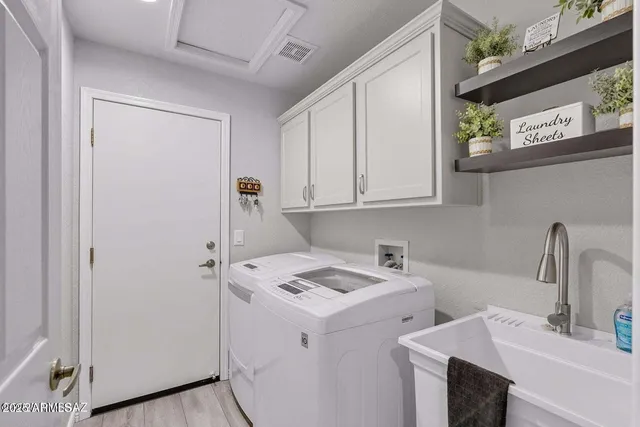 a bedroom with bed and a chandelier