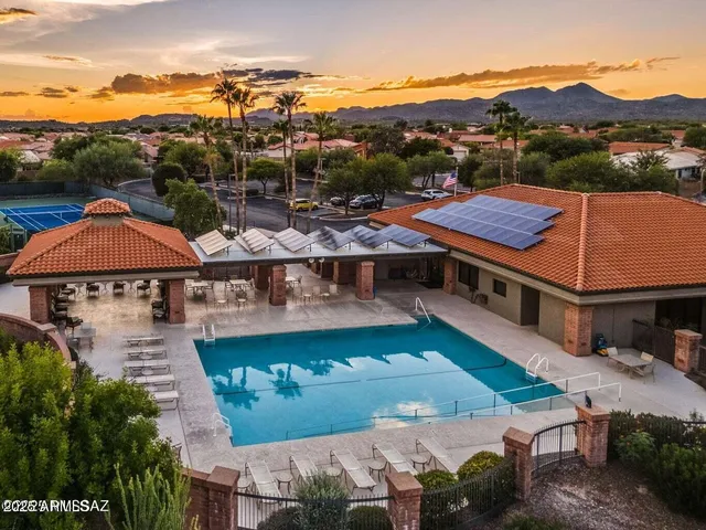 an aerial view of residential houses with outdoor space and ocean view