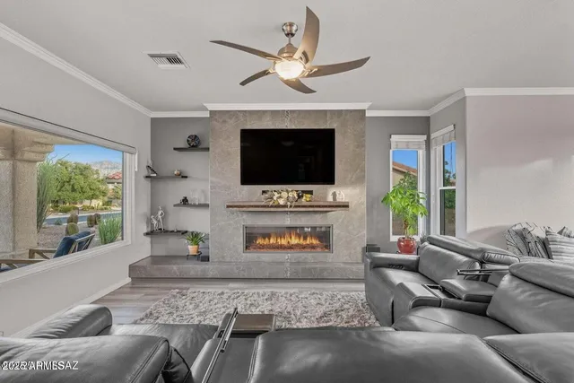 a living room with furniture a fireplace and a flat screen tv