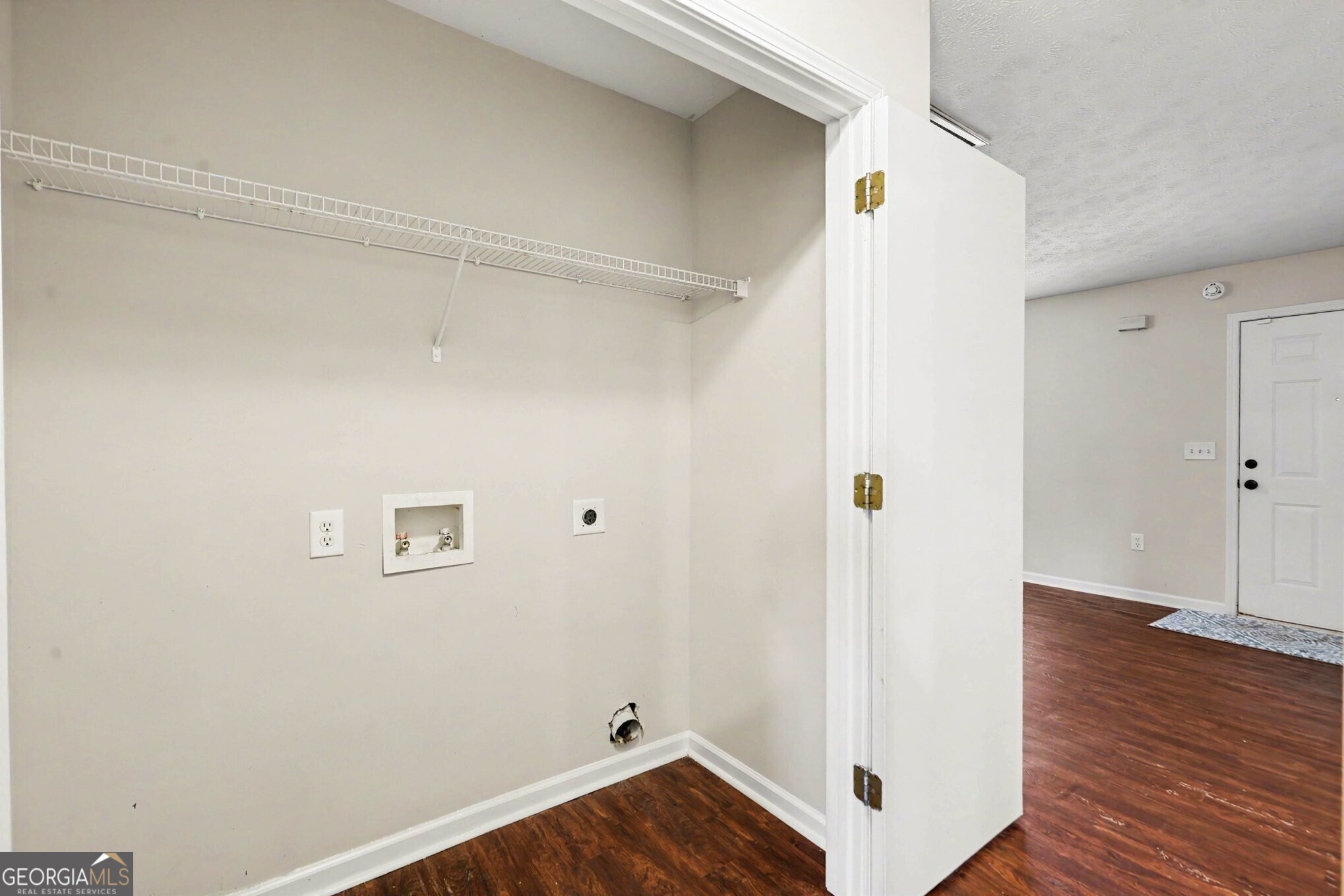 209 East Wilson Street Villa Rica, GA 30180 - Photo 7 of 24 LAUNDRY CLOSET OFF OF THE FAMILY ROOM