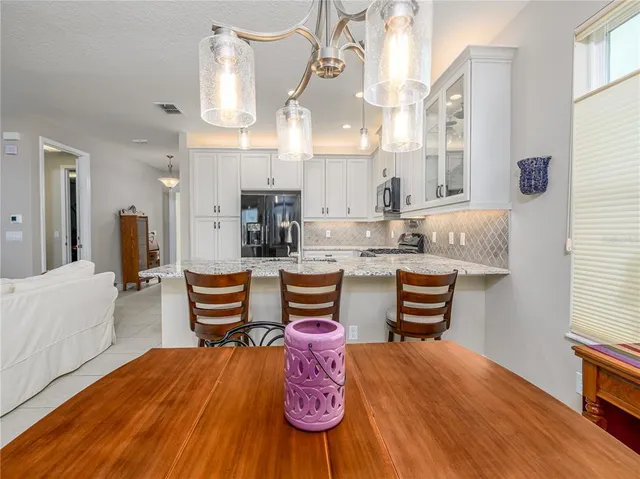 a kitchen with stainless steel appliances kitchen island granite countertop a sink and cabinets