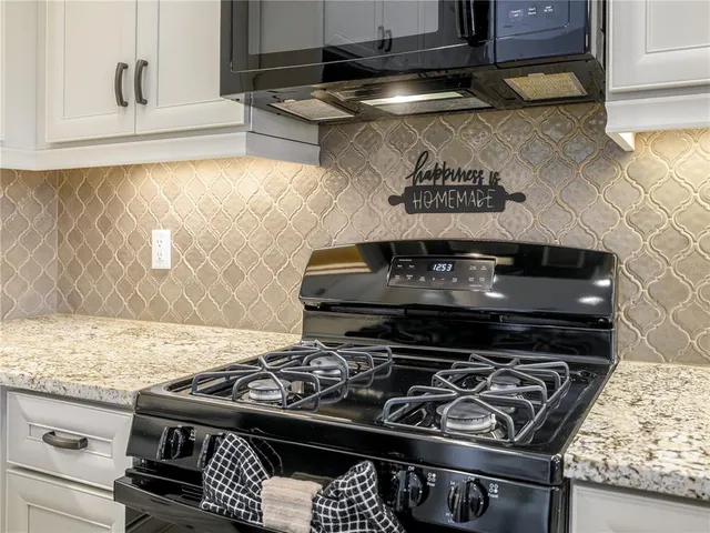 a close view of a stove a microwave and a stove