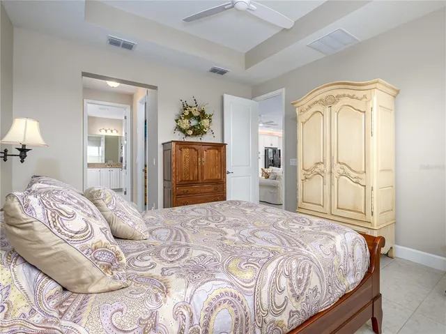 a bedroom with a bed and a chandelier