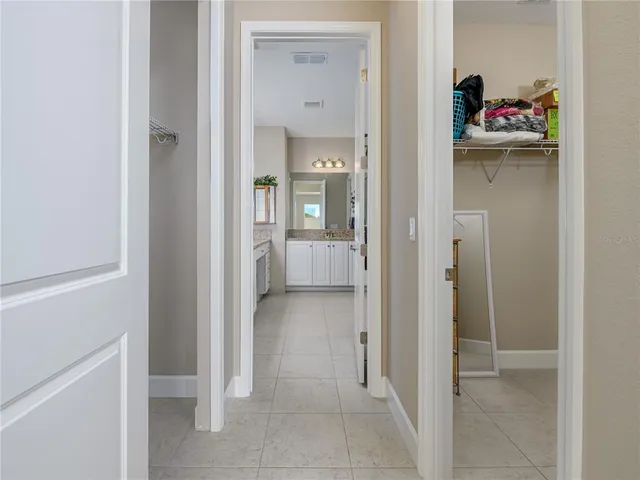 a view of a hallway with closet and wooden floor