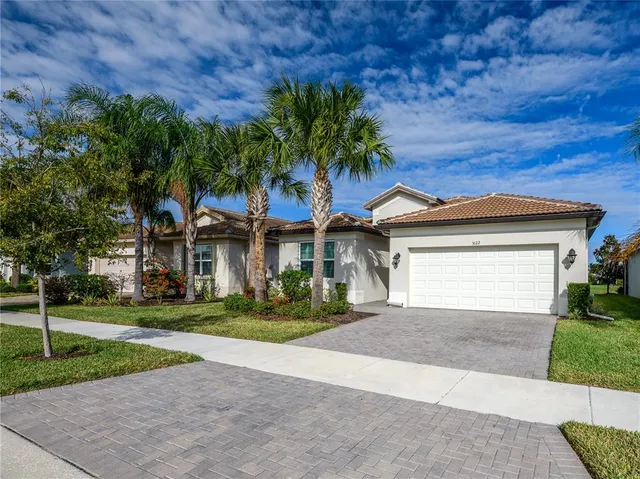 a front view of a house with a yard and garage
