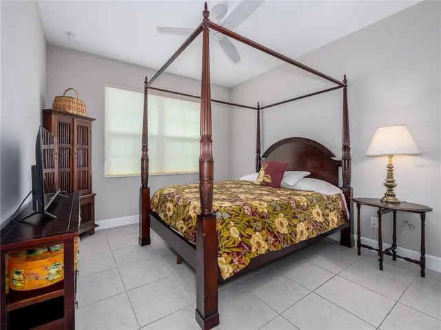 a bedroom with a bed chair and the view of bathroom