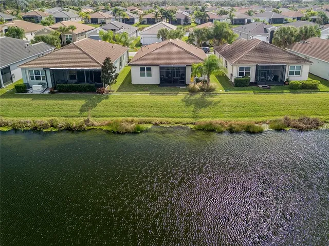 a aerial view of a house next to a big yard