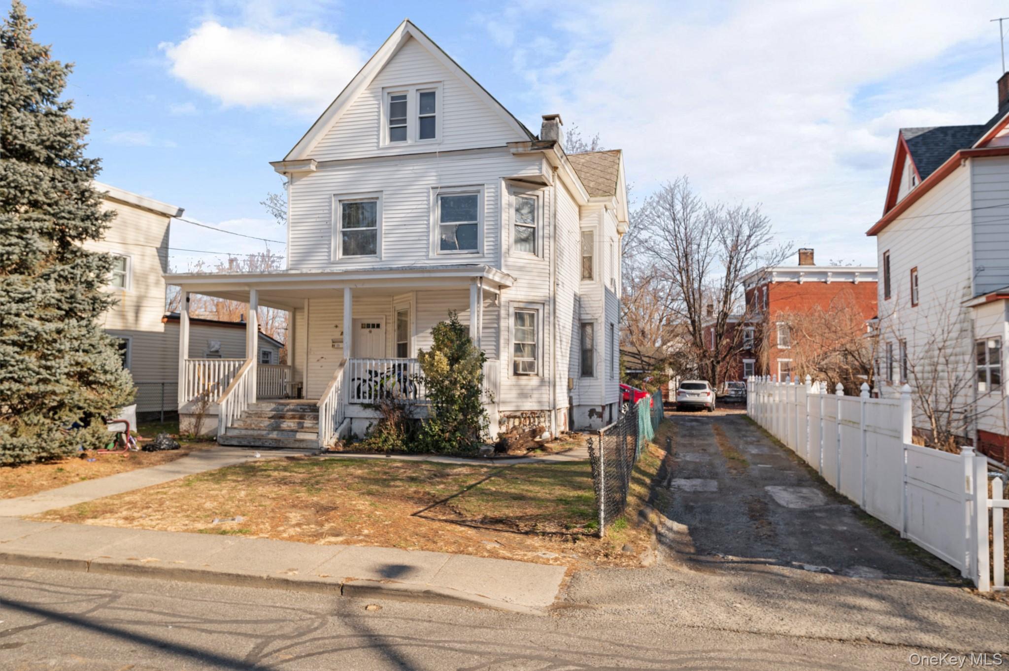 View of front of home with a porch and a chimney