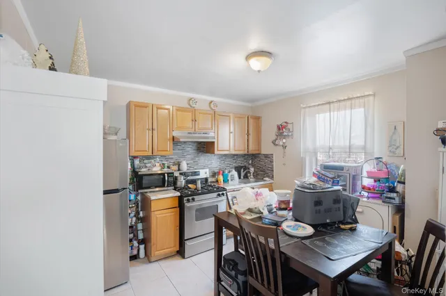 a view of a dining room with furniture and a window