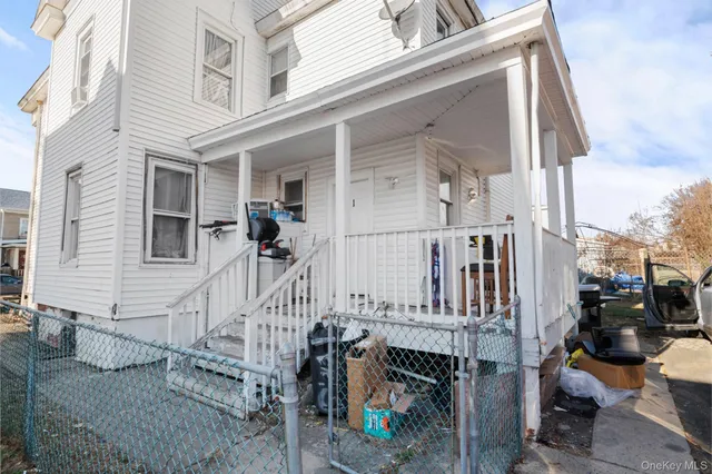 a view of a house with wooden fence