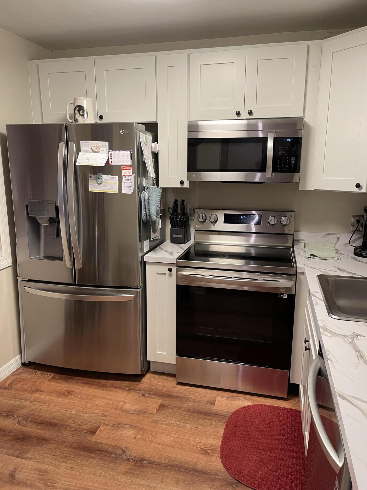 9355 Southwest 8th Street, Unit 415 Boca Raton, FL 33428 - Photo 16 of 23 a kitchen with a stove microwave and refrigerator