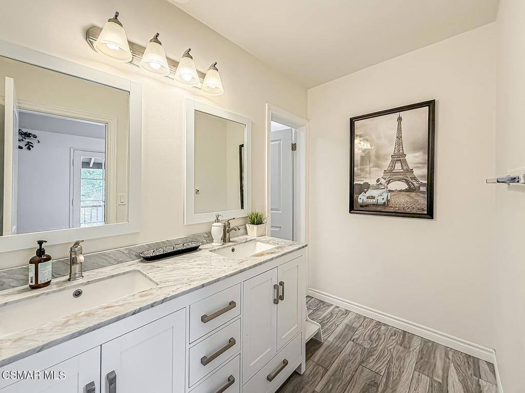 4184 Lanai Road Encino, CA 91436 - Photo 15 of 32 a bathroom with a double vanity sink and a mirror