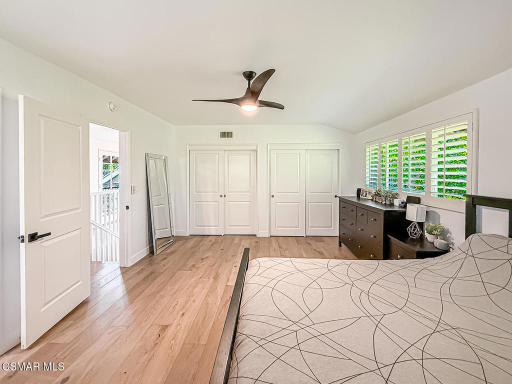 4184 Lanai Road Encino, CA 91436 - Photo 20 of 32 a large bedroom with a large bed and wooden floor