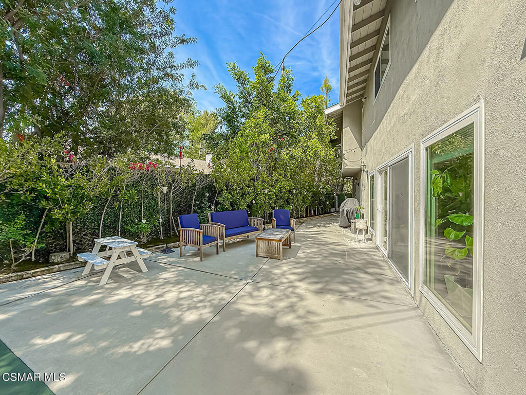 4184 Lanai Road Encino, CA 91436 - Photo 23 of 32 a view of backyard with outdoor seating and trees