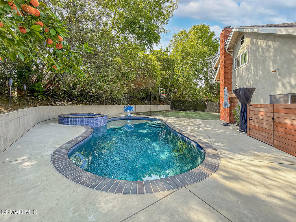 4184 Lanai Road Encino, CA 91436 - Photo 26 of 32 a view of a swimming pool with a sitting space