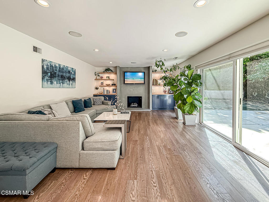4184 Lanai Road Encino, CA 91436 - Photo 4 of 32 a living room with furniture a potted plant and a floor to ceiling window