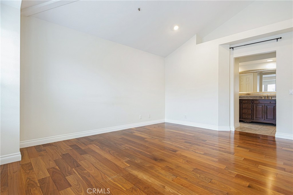 23 Ericson Aisle Irvine, CA 92620 - Photo 15 of 28 an empty room with wooden floor and windows