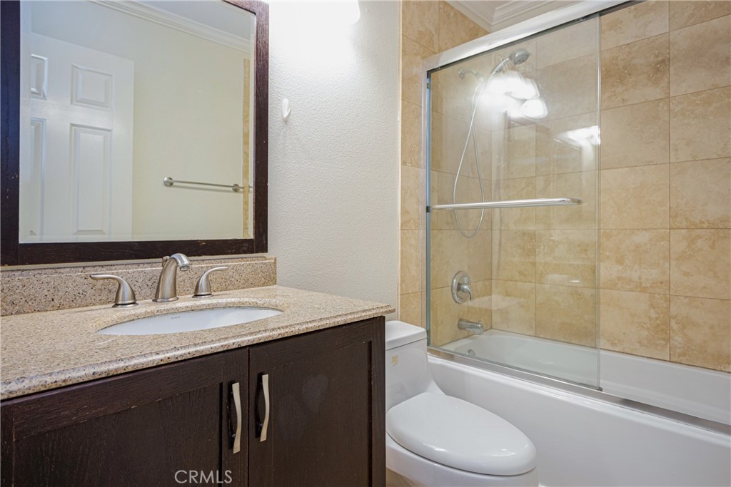 23 Ericson Aisle Irvine, CA 92620 - Photo 18 of 28 a bathroom with a granite countertop sink toilet and shower