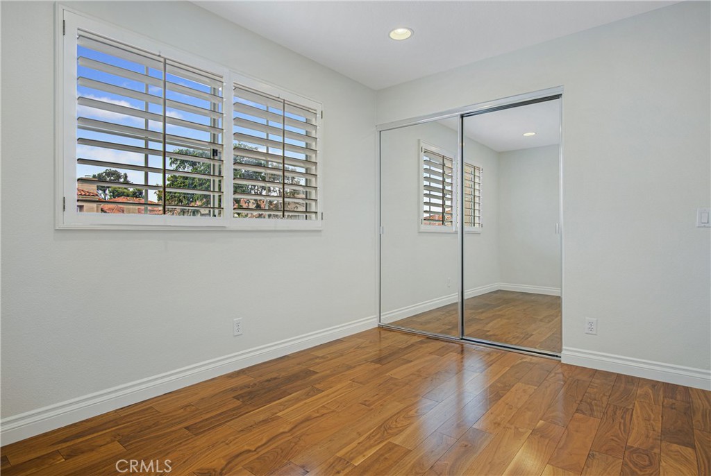 23 Ericson Aisle Irvine, CA 92620 - Photo 19 of 28 a view of an empty room with wooden floor and a window
