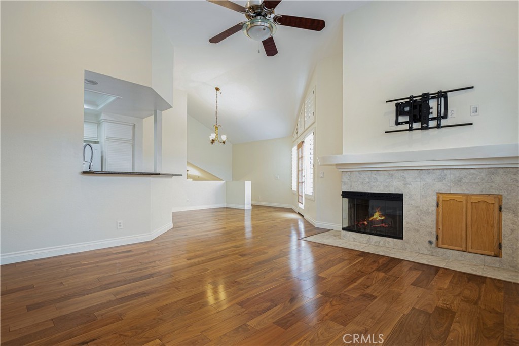 23 Ericson Aisle Irvine, CA 92620 - Photo 7 of 28 a view of an empty room with wooden floor and a fireplace
