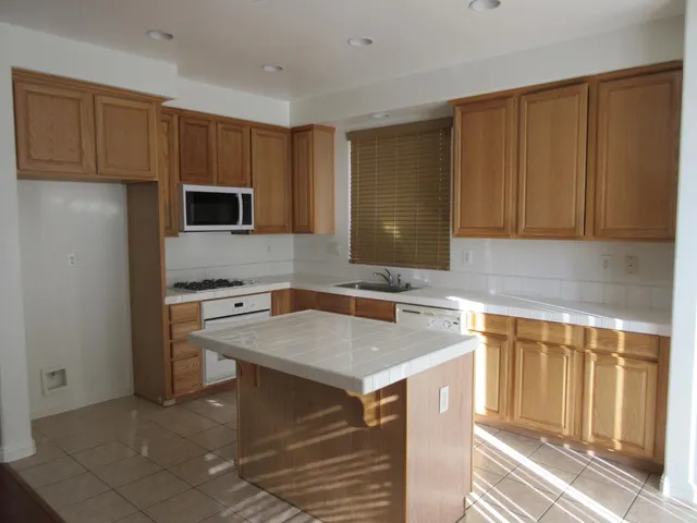 a kitchen with a sink stove and microwave