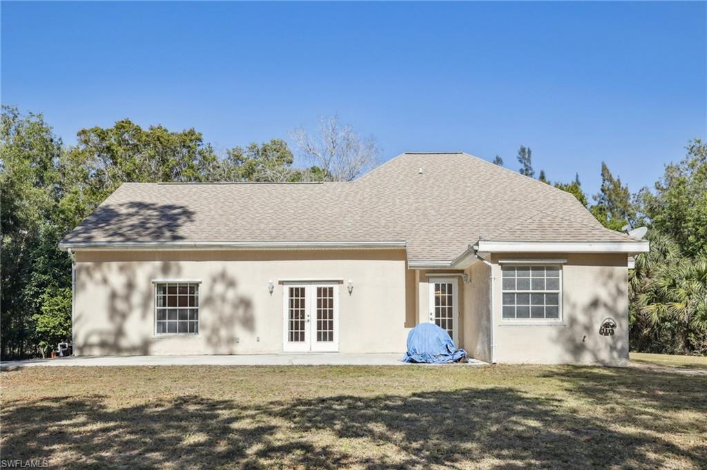 5348 Cypress Lane Naples, FL 34113 - Photo 18 of 28 front view of a house with a yard