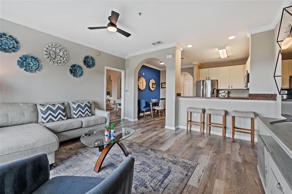 14200 Avalon Road, Unit 409 Winter Garden, FL 34787 - Photo 3 of 33 a living room with furniture and wooden floor