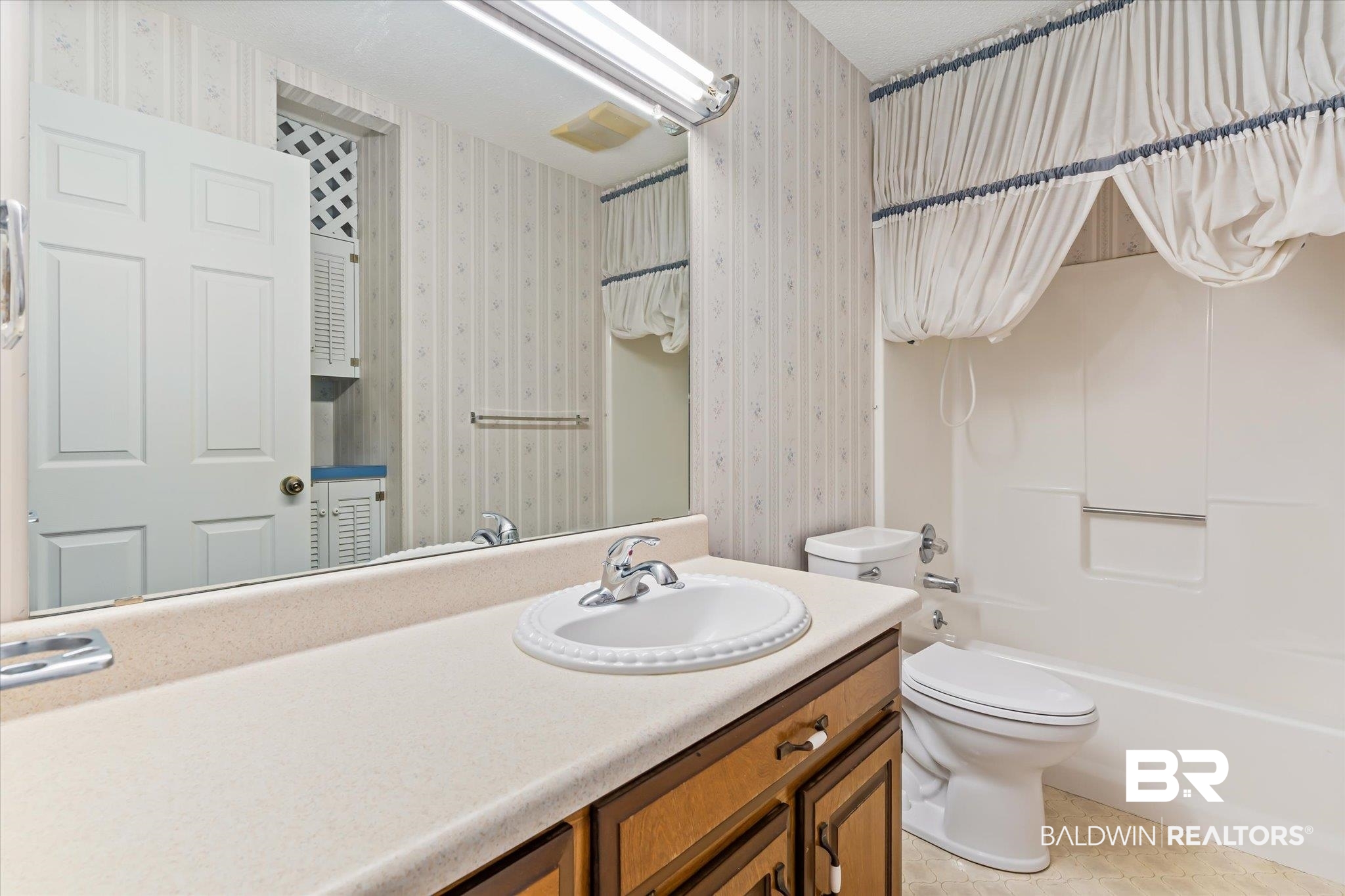 6030 Lott Road Eight Mile, AL 36613 - Photo 14 of 21 Full bathroom featuring shower / bath combination, wallpapered walls, toilet, and vanity