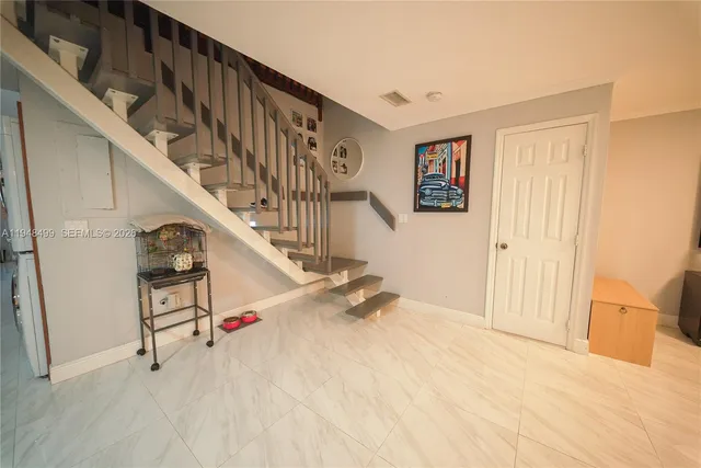 a living room with furniture and potted plant