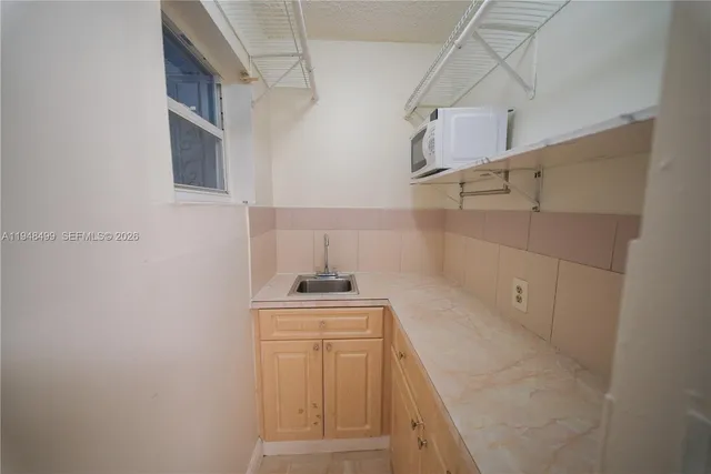 a view of an empty room and a bathroom