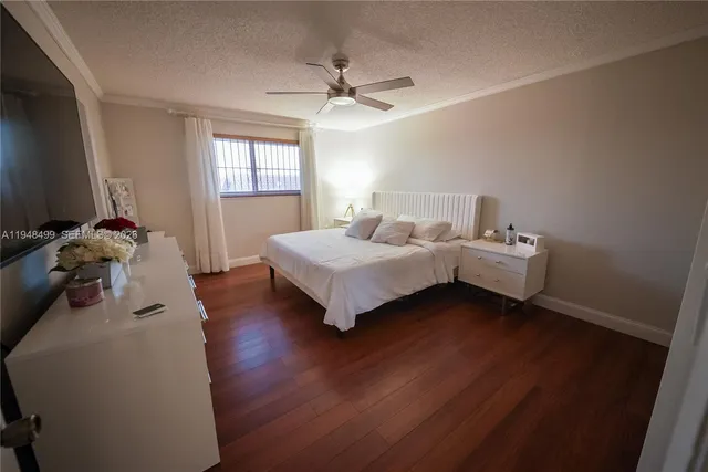 a living room with furniture a flat screen tv and kitchen view