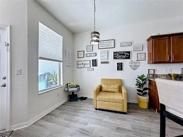 a view of a dining room with furniture window and wooden floor