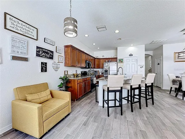 a kitchen with stainless steel appliances granite countertop a refrigerator and a sink