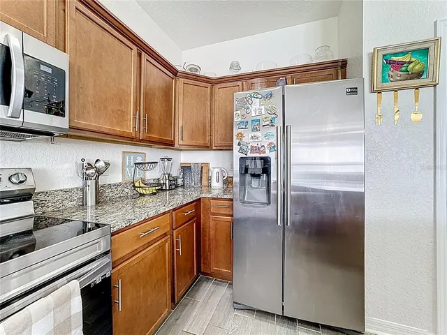 a kitchen with stainless steel appliances granite countertop a stove sink and cabinets